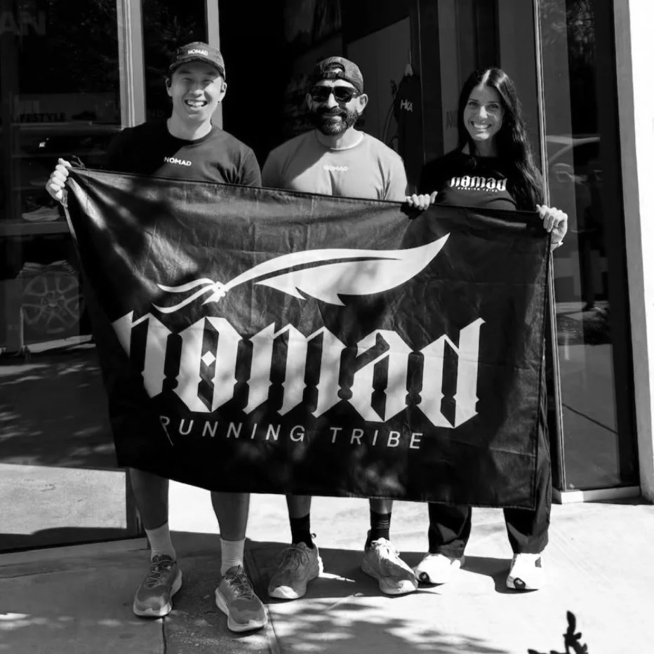 Nomad Running Tribe crew holding their flag